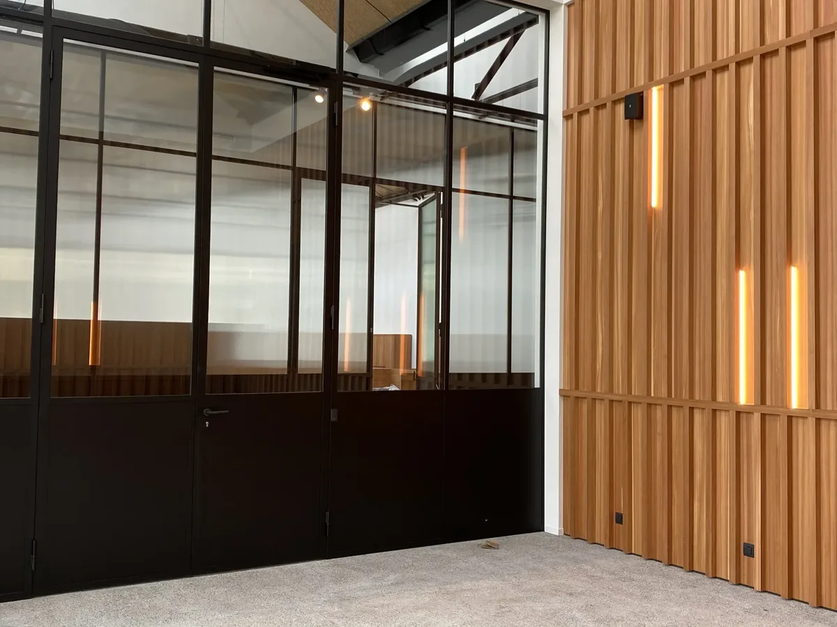 Glass office spaces with wooden slat wall in Cotton Factory